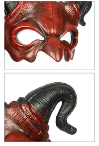 Macro detail of red and black demon mask featuring spiral horn texture and eye cutout