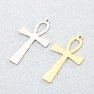 Polished titanium steel Ankh cross pendants in gold and silver finishes on white background