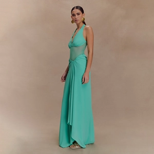 Detail of turquoise halter neck maxi dress with waist cut-outs and flowing hemline
