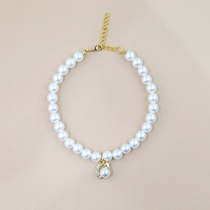 Detail of pet pearl collar with golden moon pendant and adjustable lobster clasp