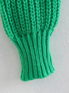 Vista macro dettagliata dei polsini a costine e della maglia testurizzata di questo maglione