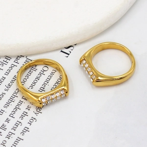 Detail shot of flat 18K gold plated titanium steel rings with square zircon inlays