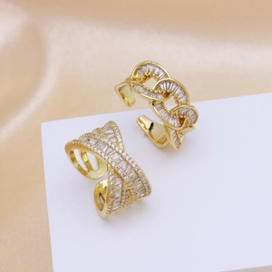Detailed view of 18k gold plated cross and chain rings set with brilliant zircons