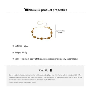 Detailed view of golden alloy textured oval waist chain with 112cm length and embossed pattern