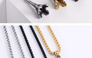 Detailed macro view of vintage Eiffel Tower pendant with PARIS engraving and beaded chain