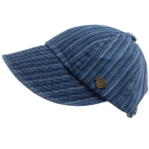 Detail of the vintage bronze crest badge on blue striped wide brim cotton baseball cap