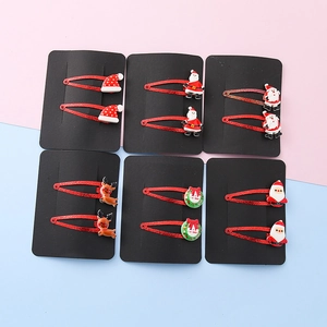Christmas hair clips set with Santa Claus and Reindeer icons on red glitter bases