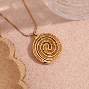 Close-up of 18K gold plated spiral vortex pendant on a sleek snake chain necklace