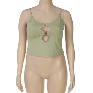 Detail view of sage green crop top with metal rings and cut-out front design