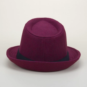Detailed view of burgundy wool felt fedora with black ribbon band and rolled edge