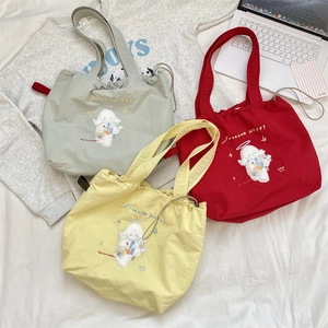 Detailed embroidery of cartoon dogs on colorful canvas tote bags with drawstring closure