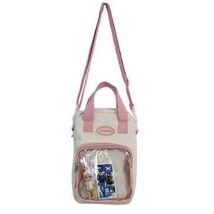Cream canvas Ita bag with clear window and pink straps showing the front detail