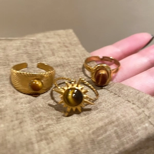 Vintage gold adjustable rings set with brown tiger eye stones and zircon accents