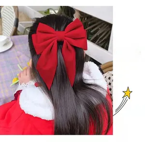 Detailed back view of a large red velvet bow hair clip worn on long straight hair
