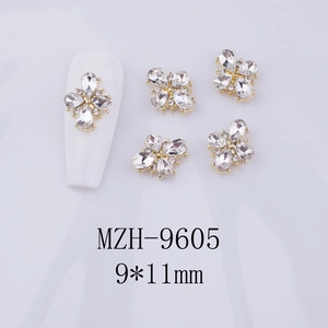 Macro shot of 9x11mm golden cross flower nail charms with clear rhinestones set of 5