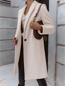 Detail of a beige mid-length wool coat with notched lapel and single button closure