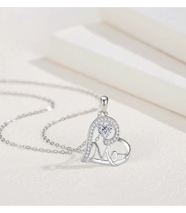 Macro shot of S925 sterling silver heart pendant with Mom lettering and zircon stones
