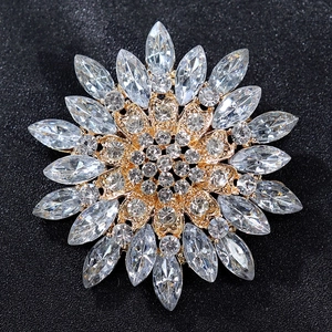 Macro detail of luxury floral brooch with golden finish and clear marquise zircons