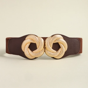 Detail of interlocking golden metal buckle on a brown elastic wide waist belt for dresses