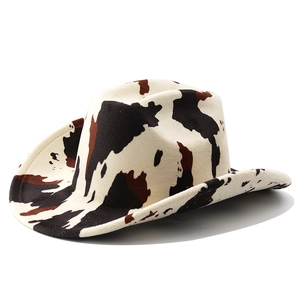 Close-up of western cow print fedora hat featuring fuzzy felt texture and wide brim