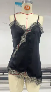 Close-up of intricate black floral lace patchwork on a satin camisole top with thin straps