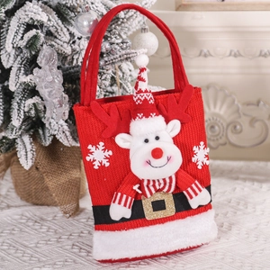 Close-up of a red knitted Christmas gift bag featuring a 3D reindeer with snow embroidery