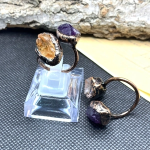 Macro detail of raw amethyst and citrine stones on vintage bronze adjustable rings