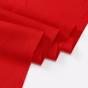 Detailed macro view of high-quality red twill fabric texture for thick winter shawls