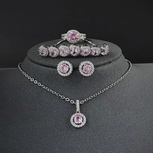Detailed luxury jewelry set featuring pink square zircon gems on a grey display stand