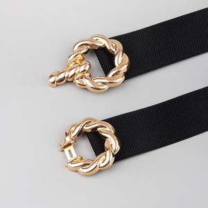 Detail of black elastic belts with gold twisted metal buckles in open and closed views