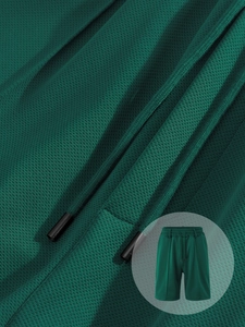 Macro detail of dark green breathable mesh fabric and drawstring on men's beach shorts