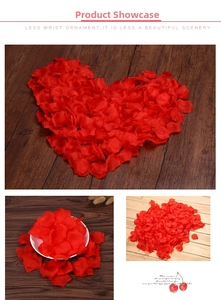 Detail of red faux rose petals scattered on wood for wedding and festive decor