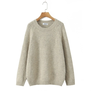 Oatmeal knit crewneck sweater with ribbed cuffs and hem shown on a wooden hanger