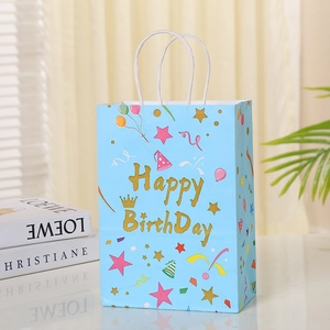 Close-up of sky blue Happy Birthday gift bag with festive patterns and white rope handles