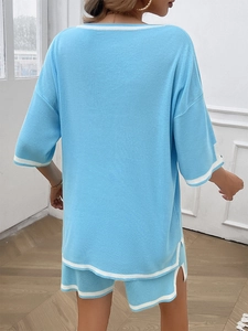 Back view of a sky blue knit lounge set with white stripe detail on the shorts and top