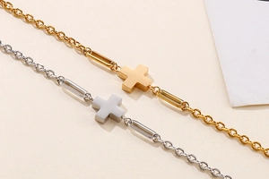 Detailed close-up of gold and silver stainless steel cross pendant bracelets