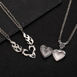Detail of vintage silver heart locket showing delicate rose floral embossing inside