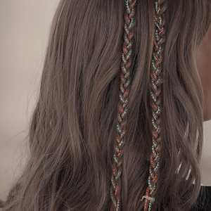 Macro view of braided hair accessory chain with colorful sparkling rhinestones