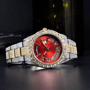 Macro detail of iced-out watch with red dial, date magnifier, and day window display