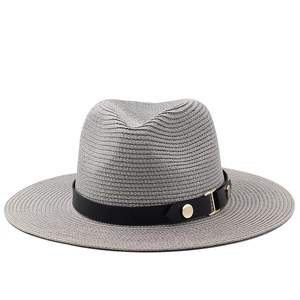 Detailed view of gray straw fedora texture and black band with gold metal buckle