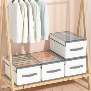 White fabric wardrobe organizer with grey handles and clear lid for clothing storage