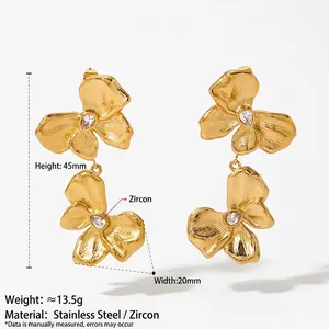 Golden matte stainless steel flower drop earrings with zircon centers on white background