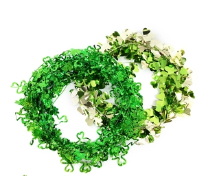 Macro detail of green shamrock tinsel garlands for St. Patrick's Day party yard decoration