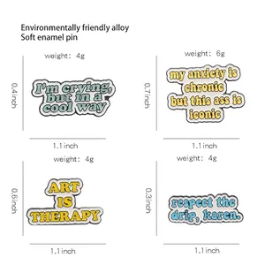 Set of four colorful enamel alloy pins with trendy letter designs in a grid display