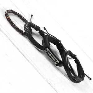 Detail of multi-layer leather bracelet with wooden beads and metal cross plate tag
