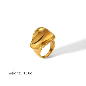 Detailed close-up of 18k gold plated stainless steel ring with irregular wavy design