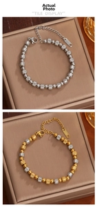 Detailed macro view of 18K gold and silver beaded bracelets with textured spiral patterns