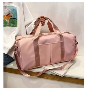 Pink nylon yoga bag with shoe compartment shown being carried by a model for travel