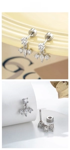 Macro detail of silver star stud earrings with zircon stones and threaded screw back