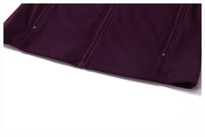 Detail of deep purple sports jacket showing smooth performance fabric and side zip pockets